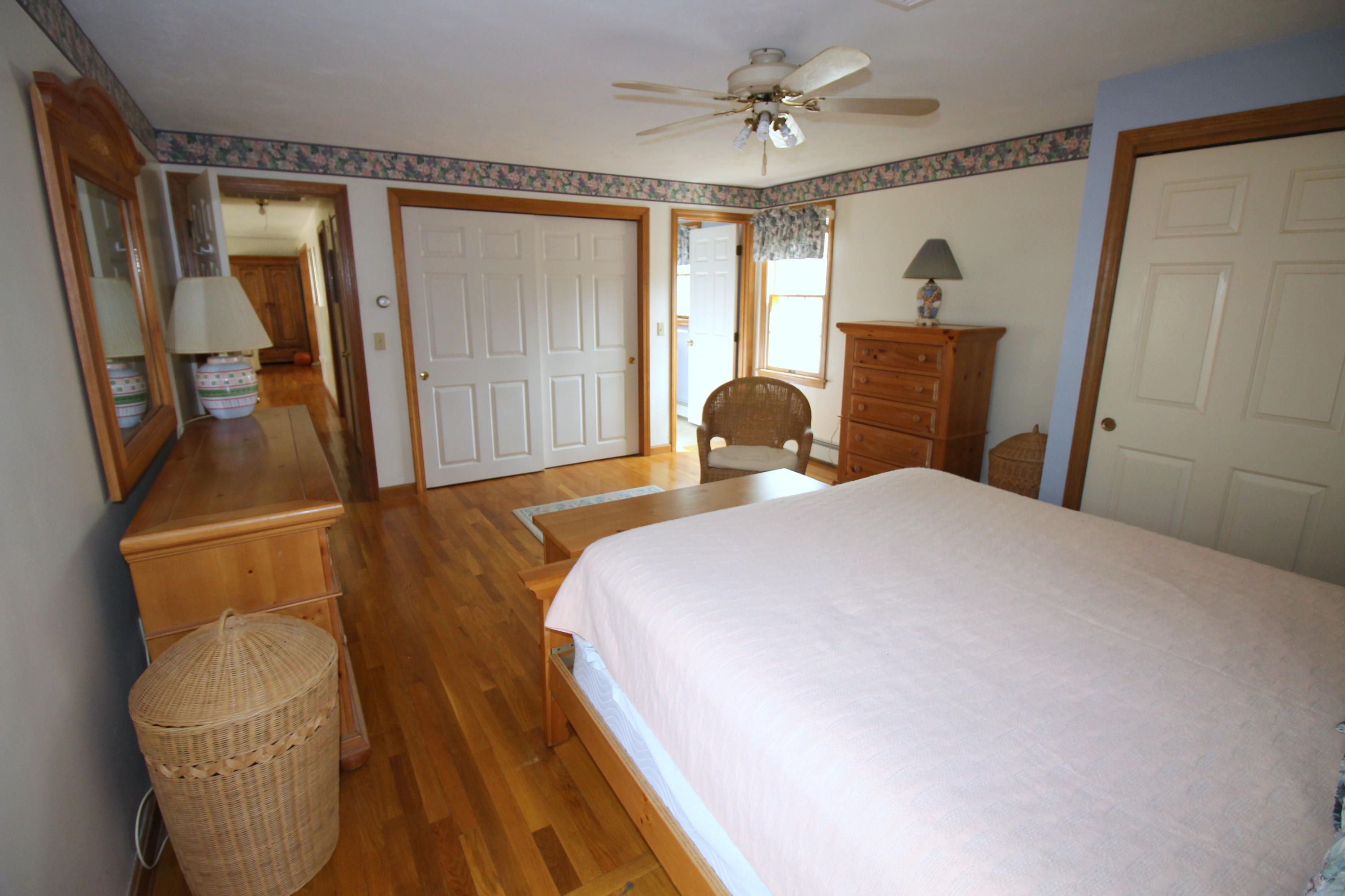9 Gates Path Dennis, MA 02638 - Photo 16 of 20 a bedroom with a bed and wooden floor