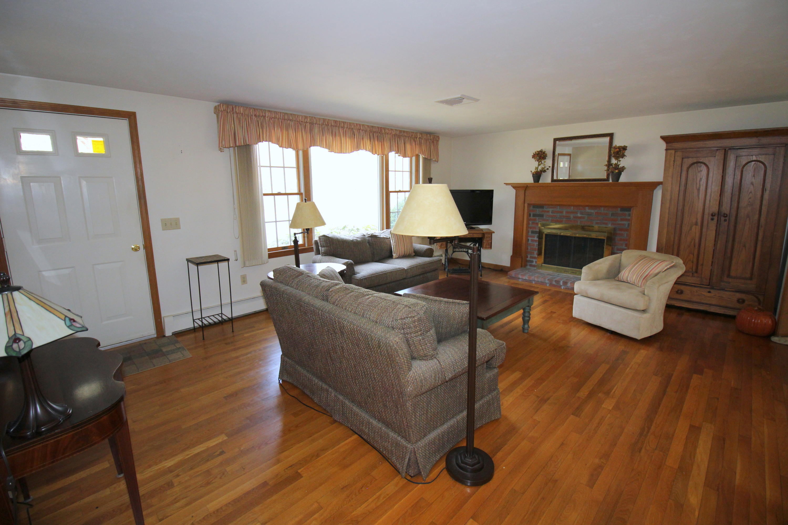 9 Gates Path Dennis, MA 02638 - Photo 2 of 20 a living room with furniture and a fireplace