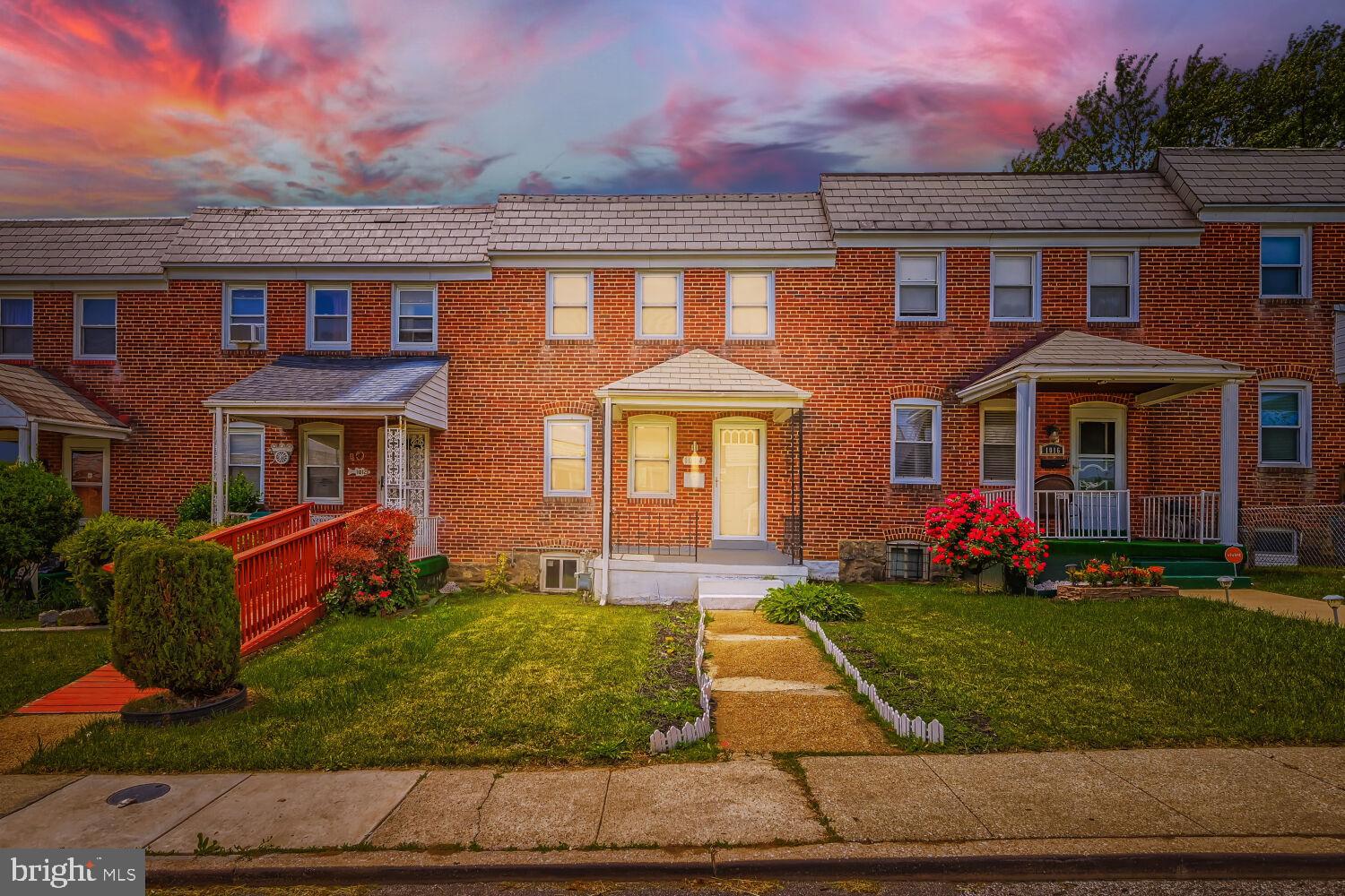 1014 Lyndhurst Street Baltimore, MD 21229 - Photo 29 of 29 front view of a brick house with a yard