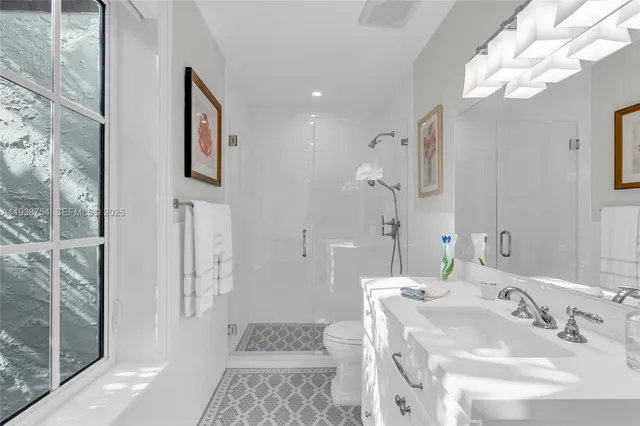 a living room with furniture a bookshelf and a window