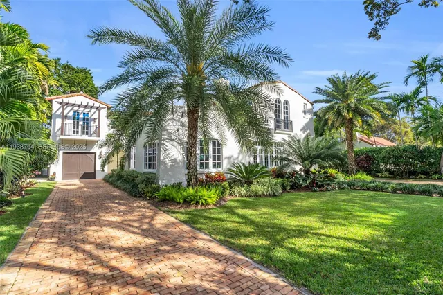 an aerial view of a house with a yard and potted plants