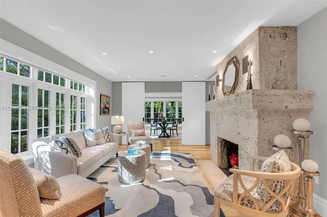 a living room with furniture fireplace and a floor to ceiling window