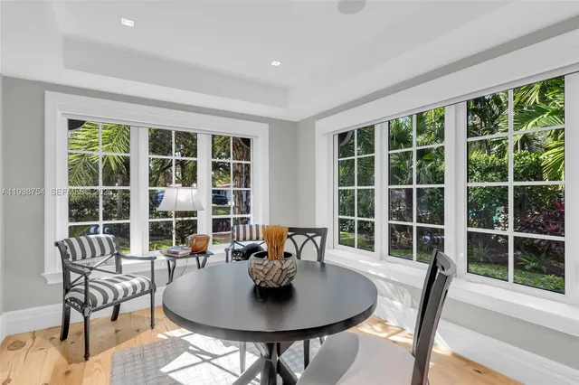 a dining room with furniture window and outside view