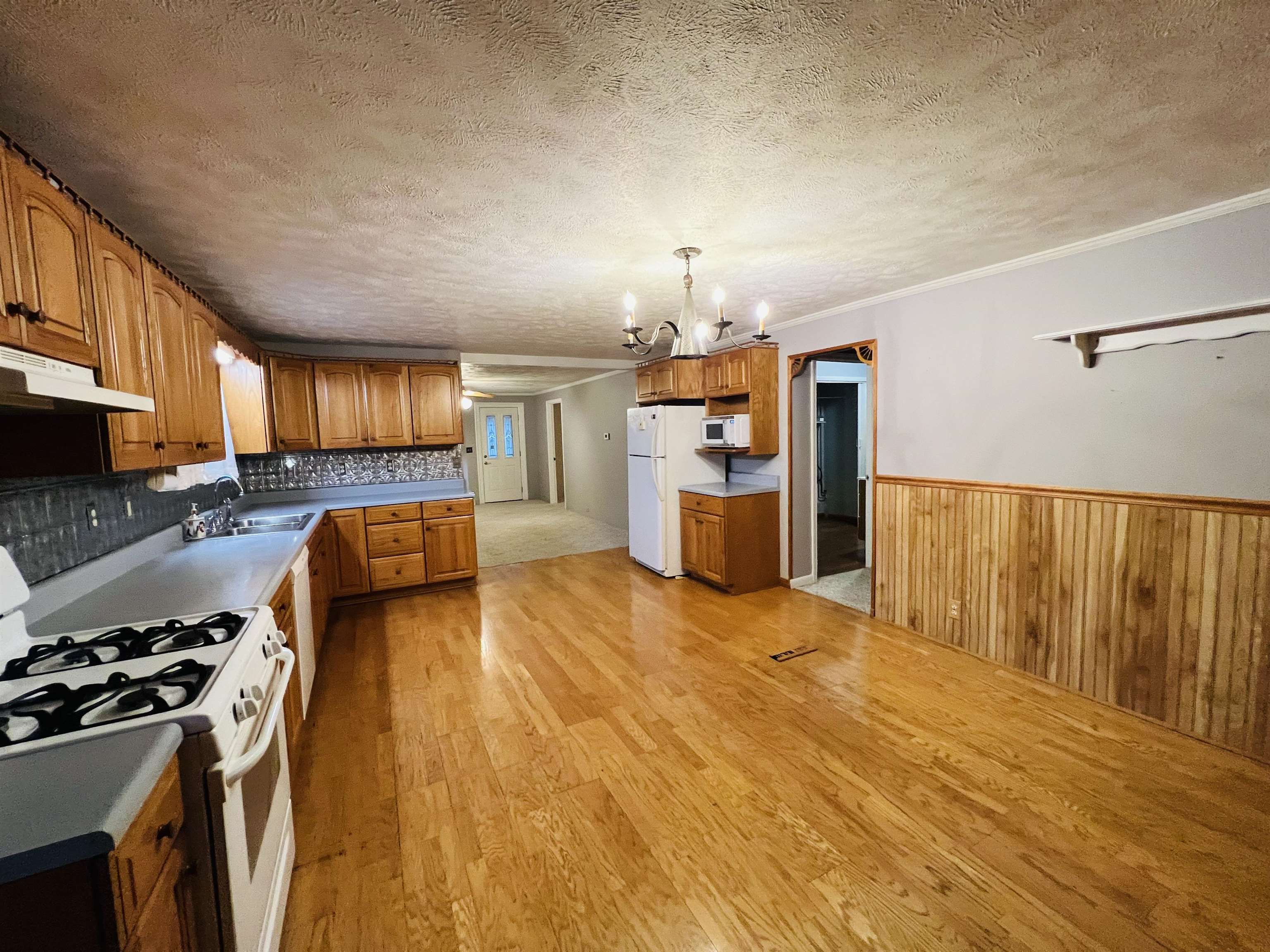 191 West Davis Street Equality, IL 62934 - Photo 14 of 21 a kitchen with stainless steel appliances granite countertop a sink dishwasher stove and refrigerator