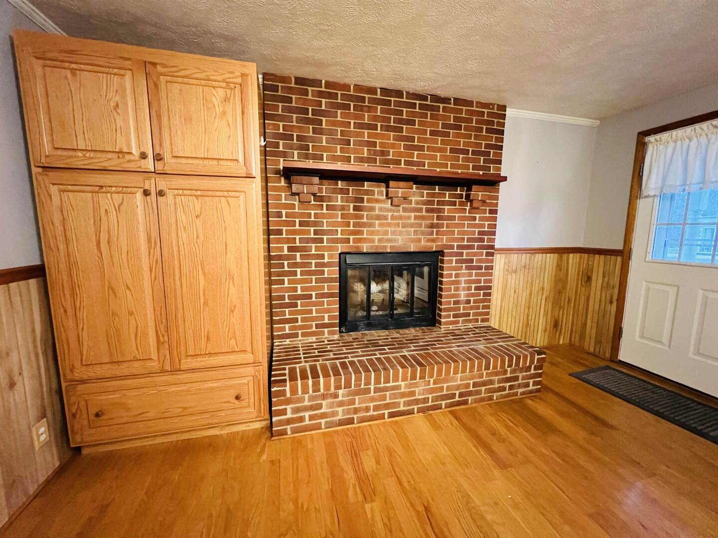 191 West Davis Street Equality, IL 62934 - Photo 15 of 21 a view of empty room with wooden floor and fireplace
