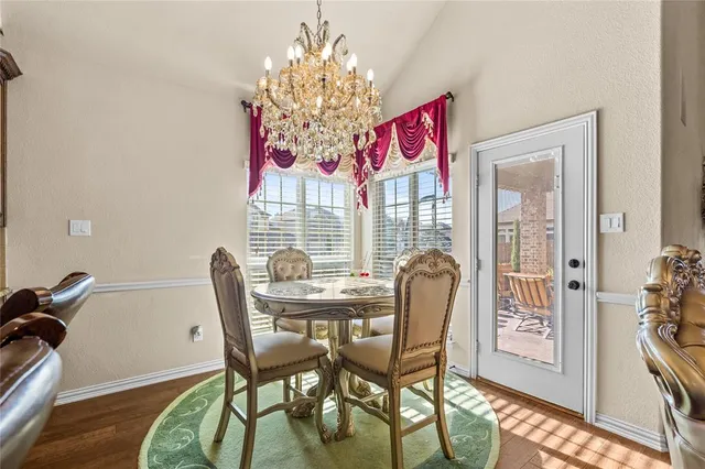 a view of a dining room with furniture and chandelier