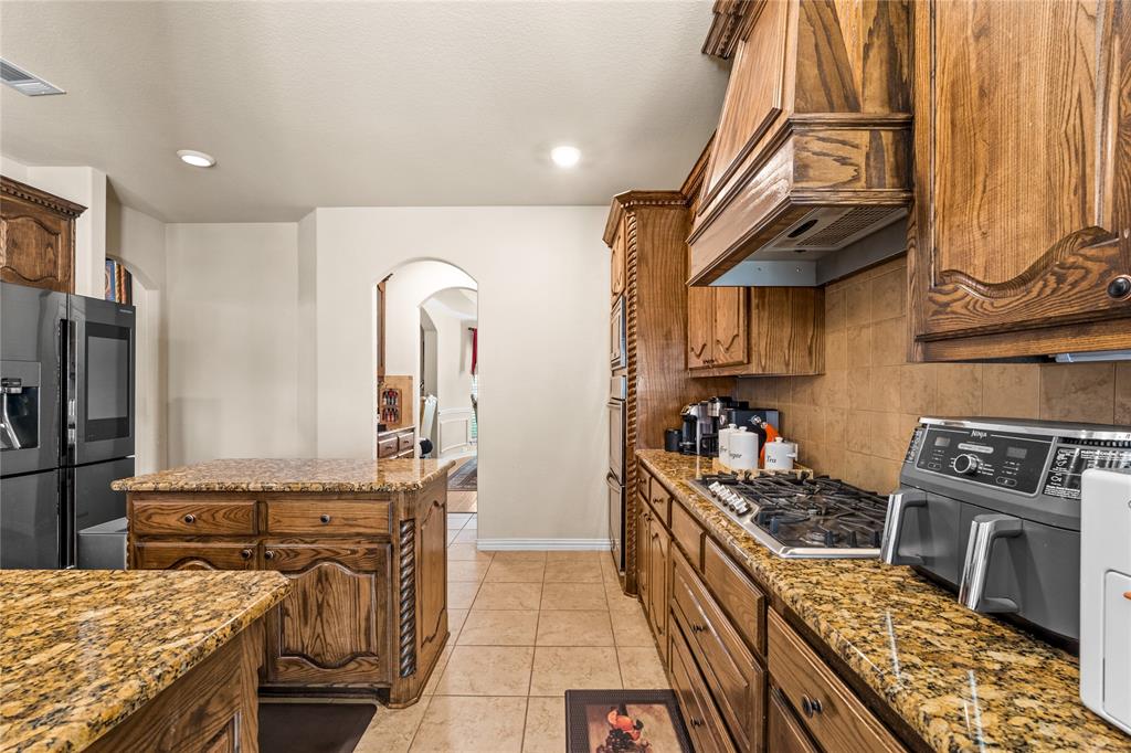 9801 Nolina Road Fort Worth, TX 76177 - Photo 13 of 40 a kitchen with stainless steel appliances granite countertop a stove and a sink