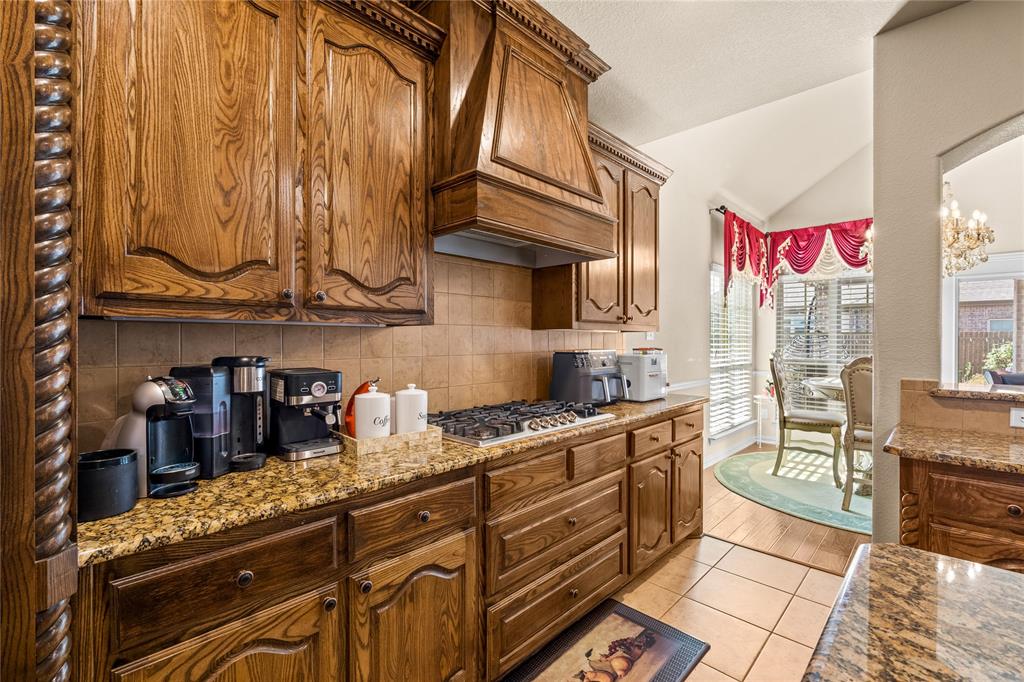 9801 Nolina Road Fort Worth, TX 76177 - Photo 15 of 40 a kitchen with stainless steel appliances granite countertop a sink and cabinets