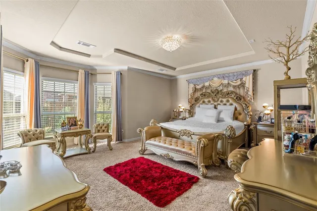 a bedroom with furniture and a large window