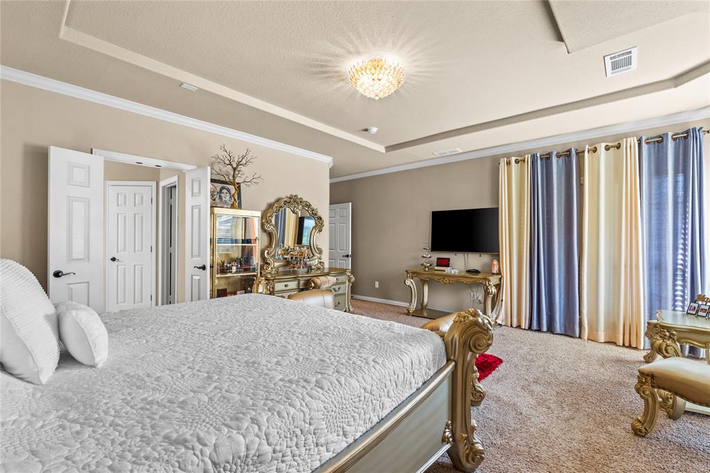 9801 Nolina Road Fort Worth, TX 76177 - Photo 19 of 40 a bedroom with a bed and a flat screen tv