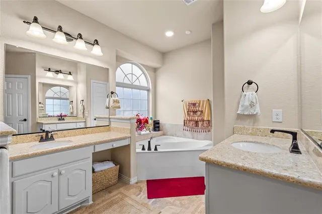 a bathroom with a granite countertop sink mirror and a