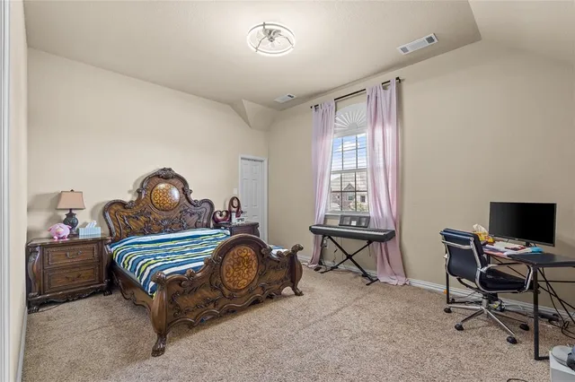 a bedroom with a bed and a desk