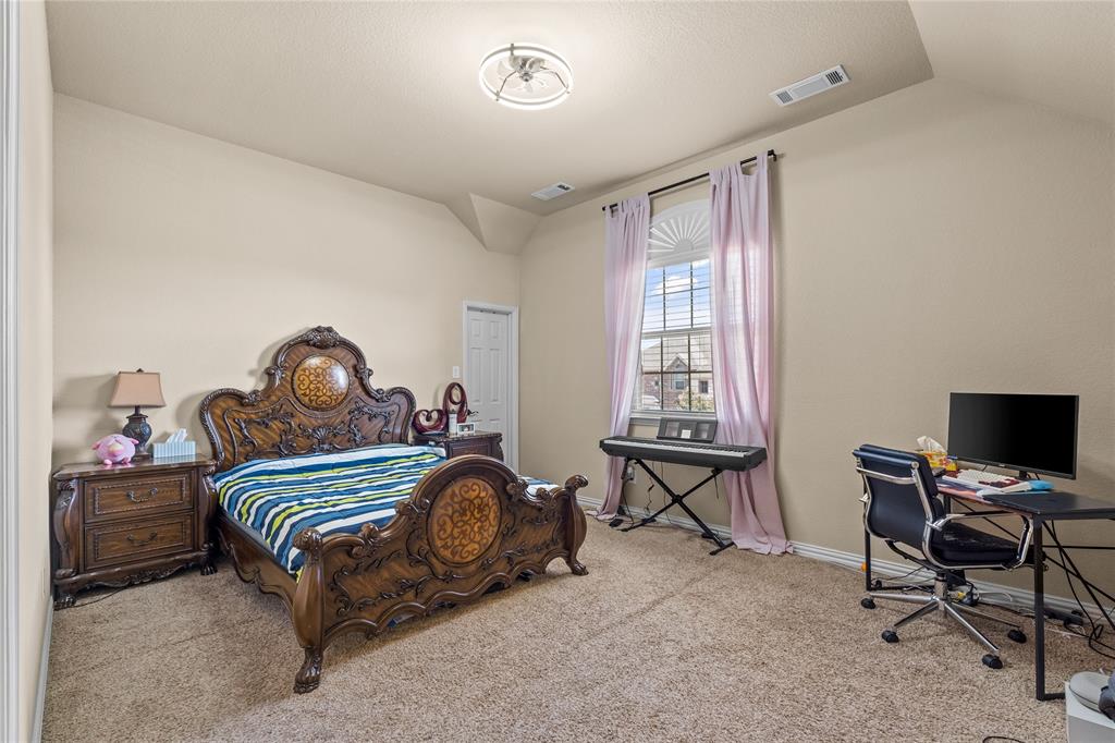 9801 Nolina Road Fort Worth, TX 76177 - Photo 23 of 40 a bedroom with a bed and a desk