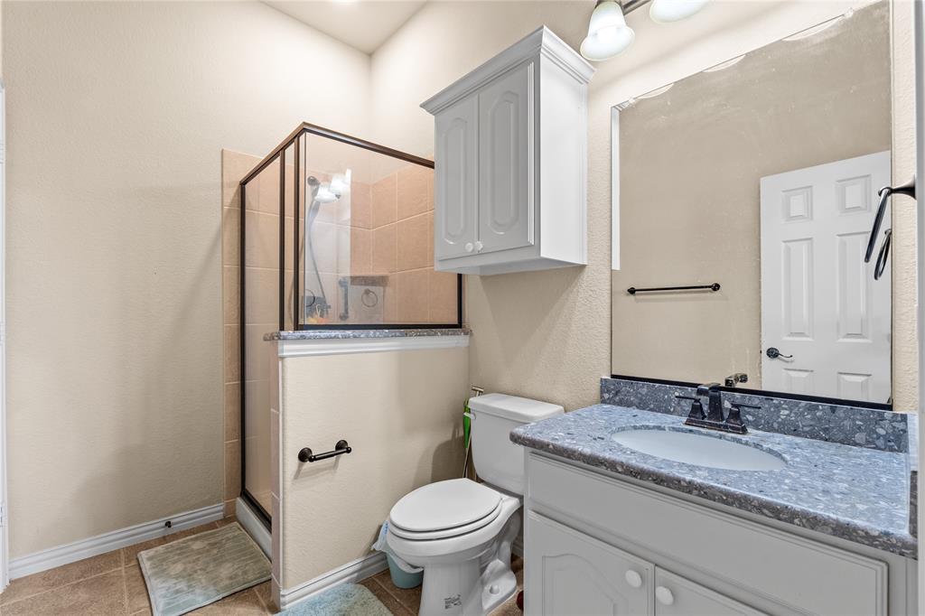 9801 Nolina Road Fort Worth, TX 76177 - Photo 24 of 40 a bathroom with a granite countertop sink toilet and shower