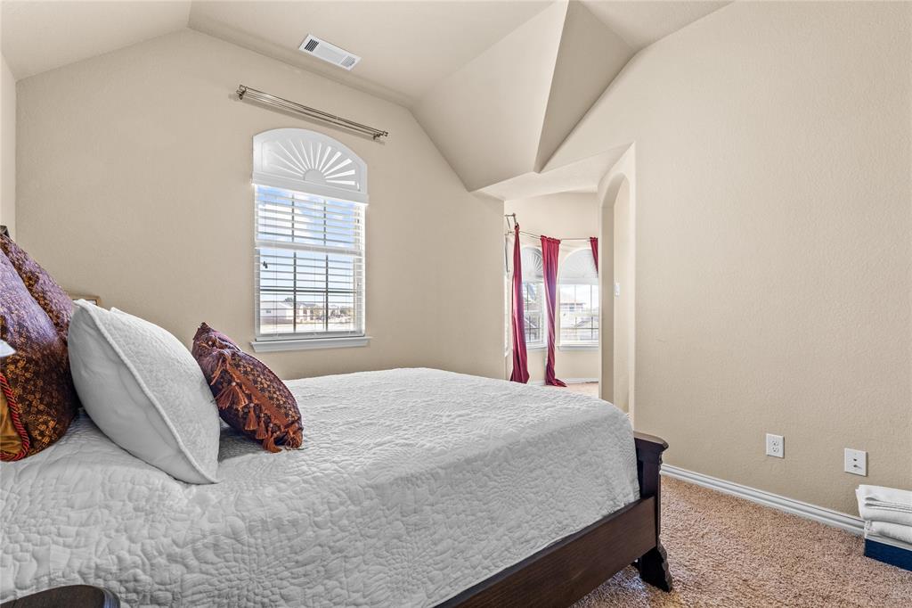 9801 Nolina Road Fort Worth, TX 76177 - Photo 25 of 40 a bed sitting in a bedroom next to a window