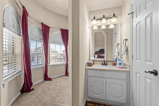 a bathroom with a sink vanity and mirror
