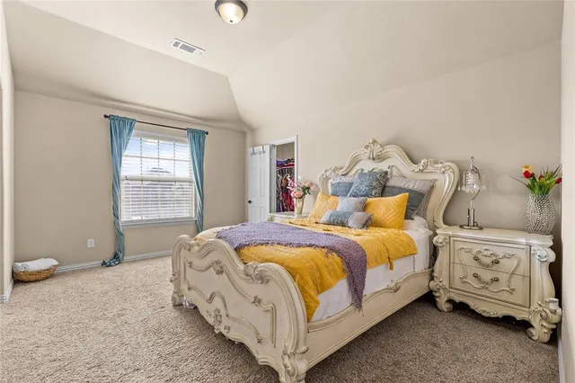 a bed room with a bed and a chair