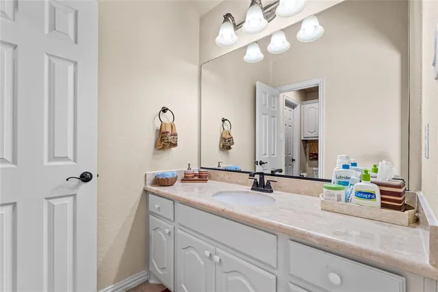 a bathroom with a sink vanity and a mirror
