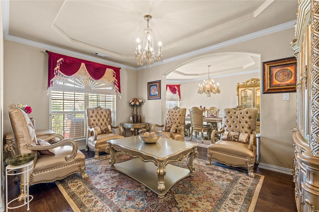 9801 Nolina Road Fort Worth, TX 76177 - Photo 5 of 40 a living room with furniture a rug and a chandelier