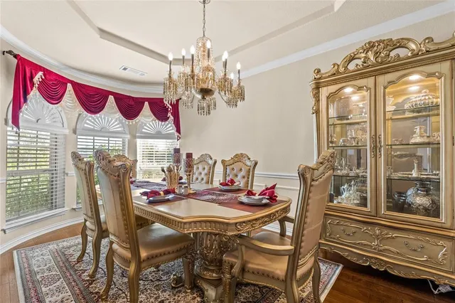 a view of a dining room with furniture wooden floor and a chandelier