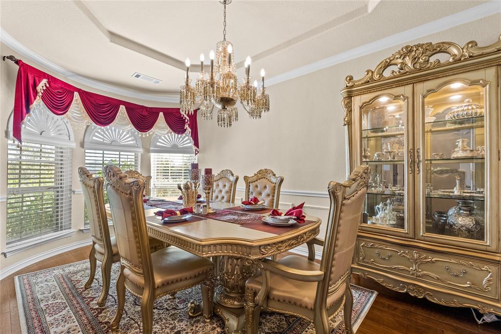 9801 Nolina Road Fort Worth, TX 76177 - Photo 6 of 40 a view of a dining room with furniture wooden floor and a chandelier