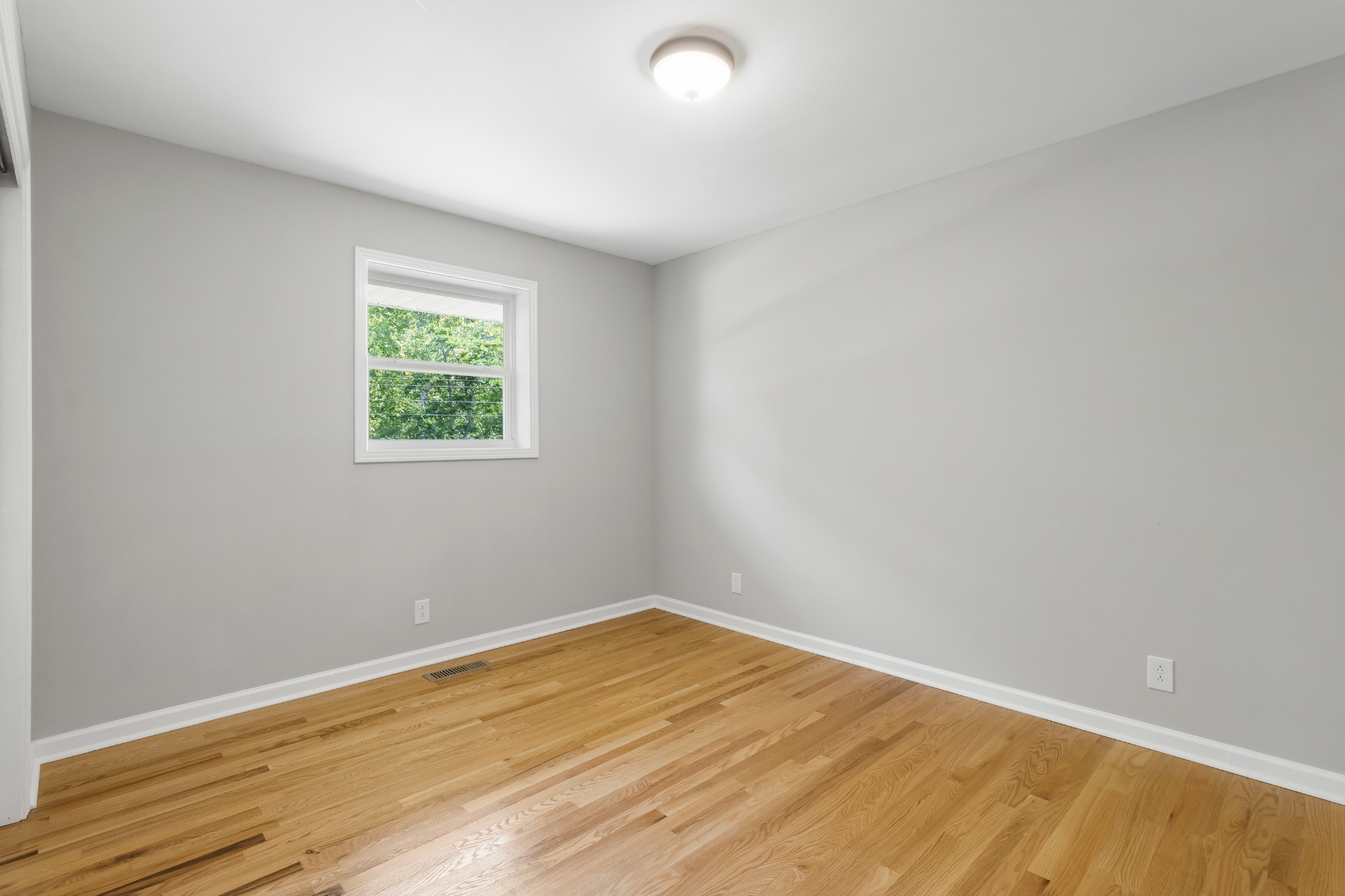 3822 Vernon Creek Road Cunningham, TN 37052 - Photo 13 of 24 an empty room with wooden floor and windows