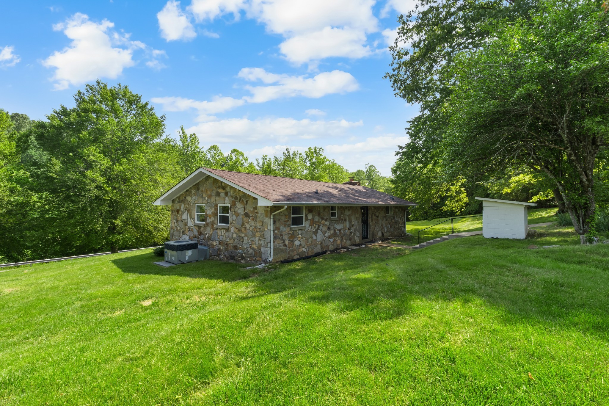 3822 Vernon Creek Road Cunningham, TN 37052 - Photo 22 of 24 a view of a house with a big yard and large trees