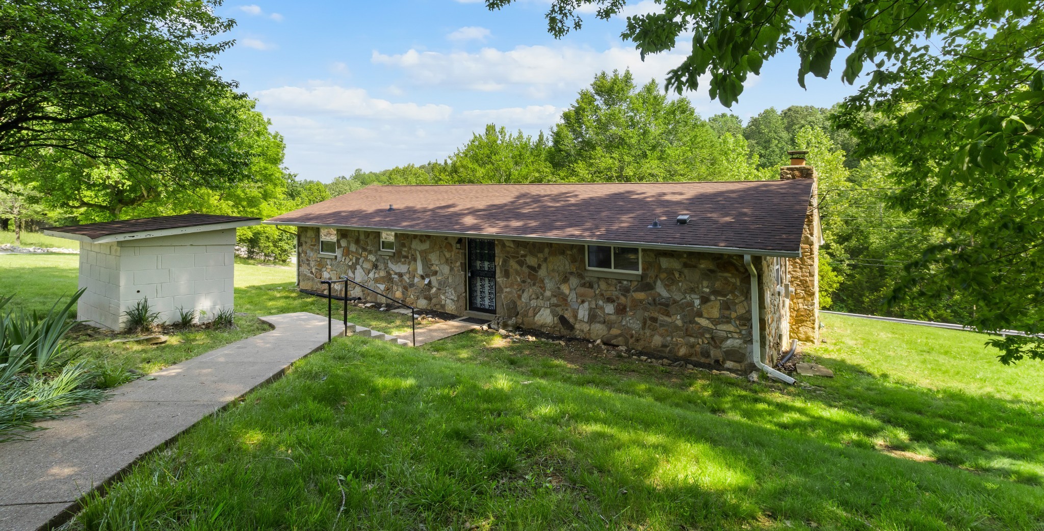 3822 Vernon Creek Road Cunningham, TN 37052 - Photo 24 of 24 a view of a house with a yard plants and large tree