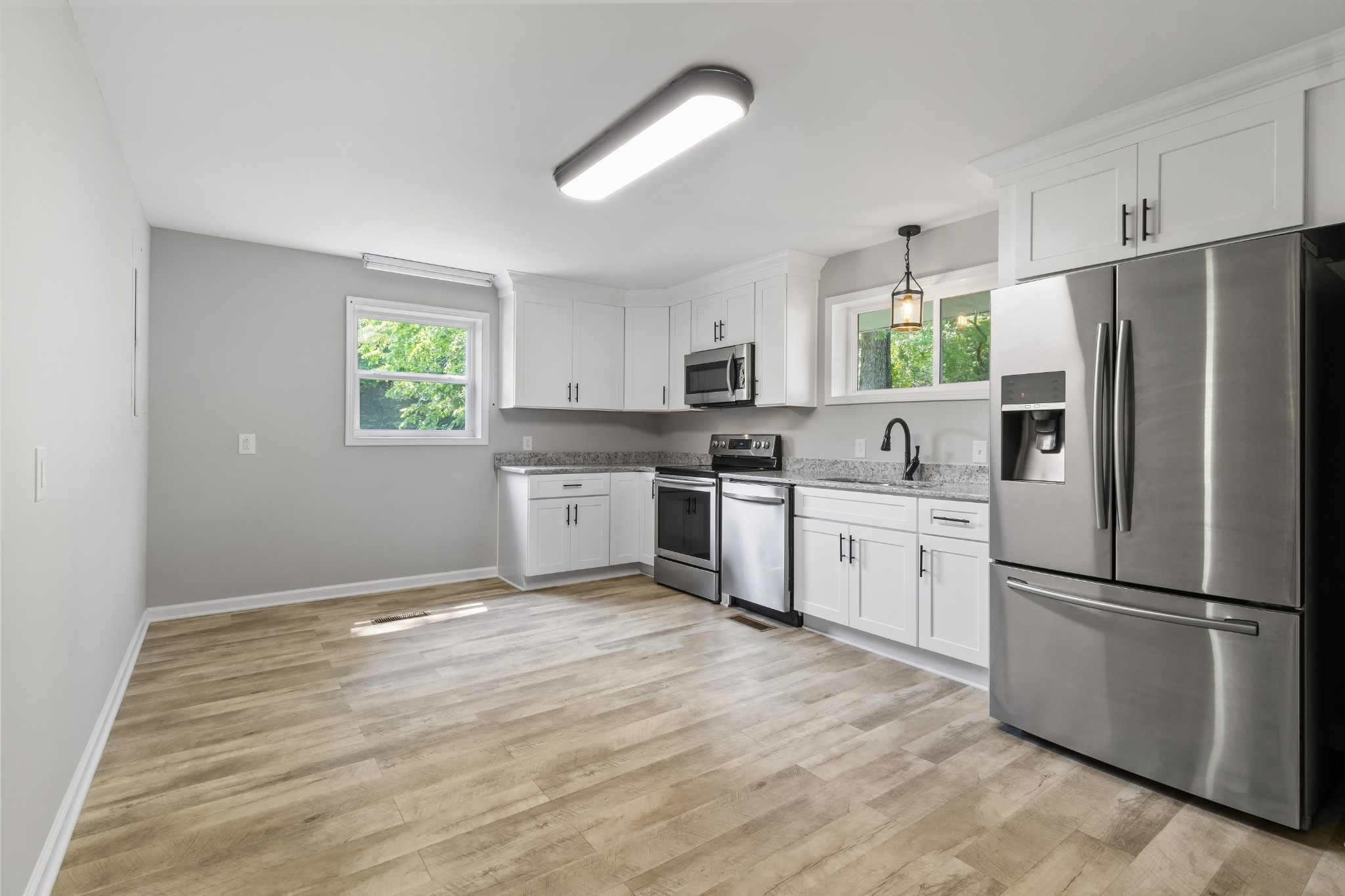 3822 Vernon Creek Road Cunningham, TN 37052 - Photo 7 of 24 a kitchen with white cabinets and white appliances