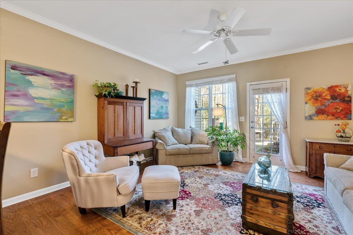 2924 Casona Way Raleigh, NC 27616 - Photo 11 of 21 a living room with furniture a rug and a chandelier