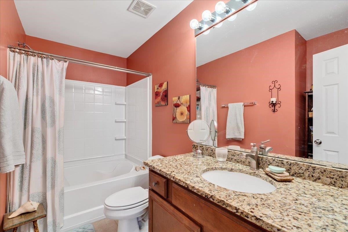 2924 Casona Way Raleigh, NC 27616 - Photo 15 of 21 a bathroom with a granite countertop sink a toilet a mirror and shower