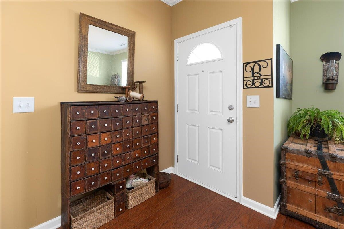 2924 Casona Way Raleigh, NC 27616 - Photo 2 of 21 a view of a hallway with front door and wooden floor