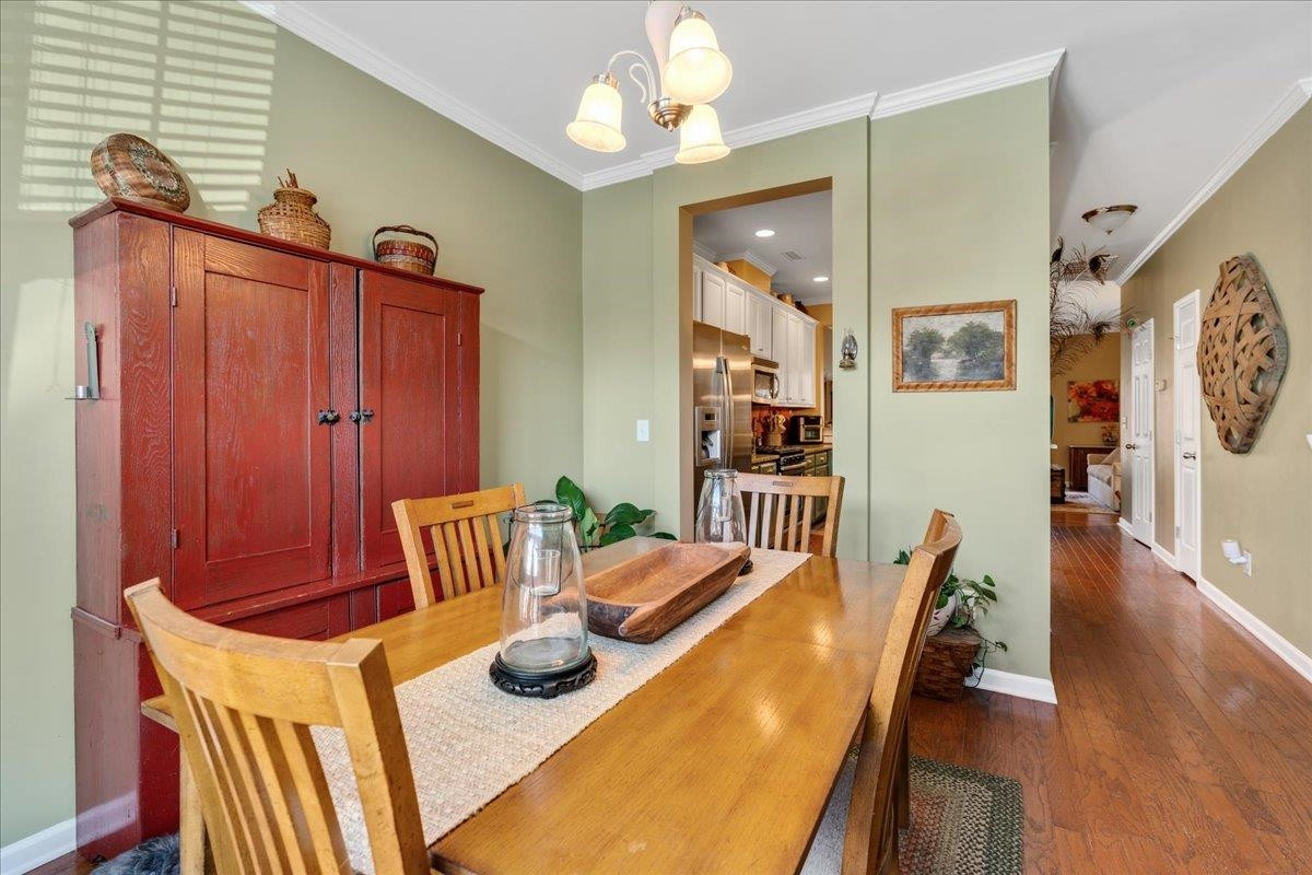 2924 Casona Way Raleigh, NC 27616 - Photo 4 of 21 a view of a dining room with furniture and wooden floor