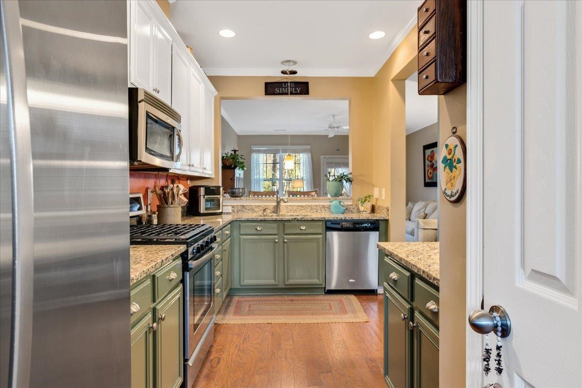 2924 Casona Way Raleigh, NC 27616 - Photo 6 of 21 a kitchen with stainless steel appliances granite countertop a stove and a refrigerator
