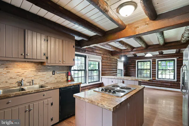 a kitchen with a stove sink and cabinets