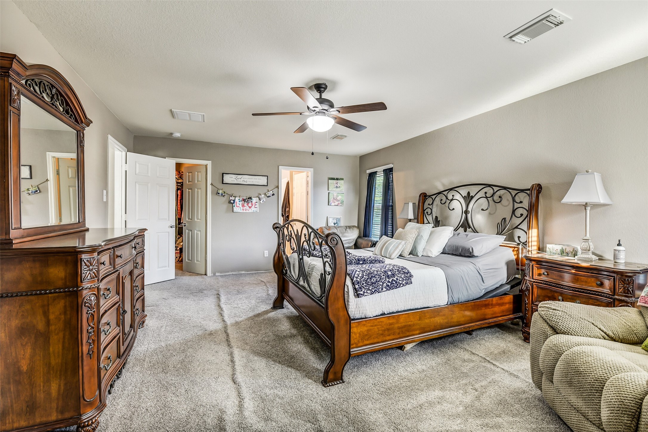 6407 Misty Brook Bend Court Spring, TX 77379 - Photo 12 of 15 a bedroom with a bed and a chandelier
