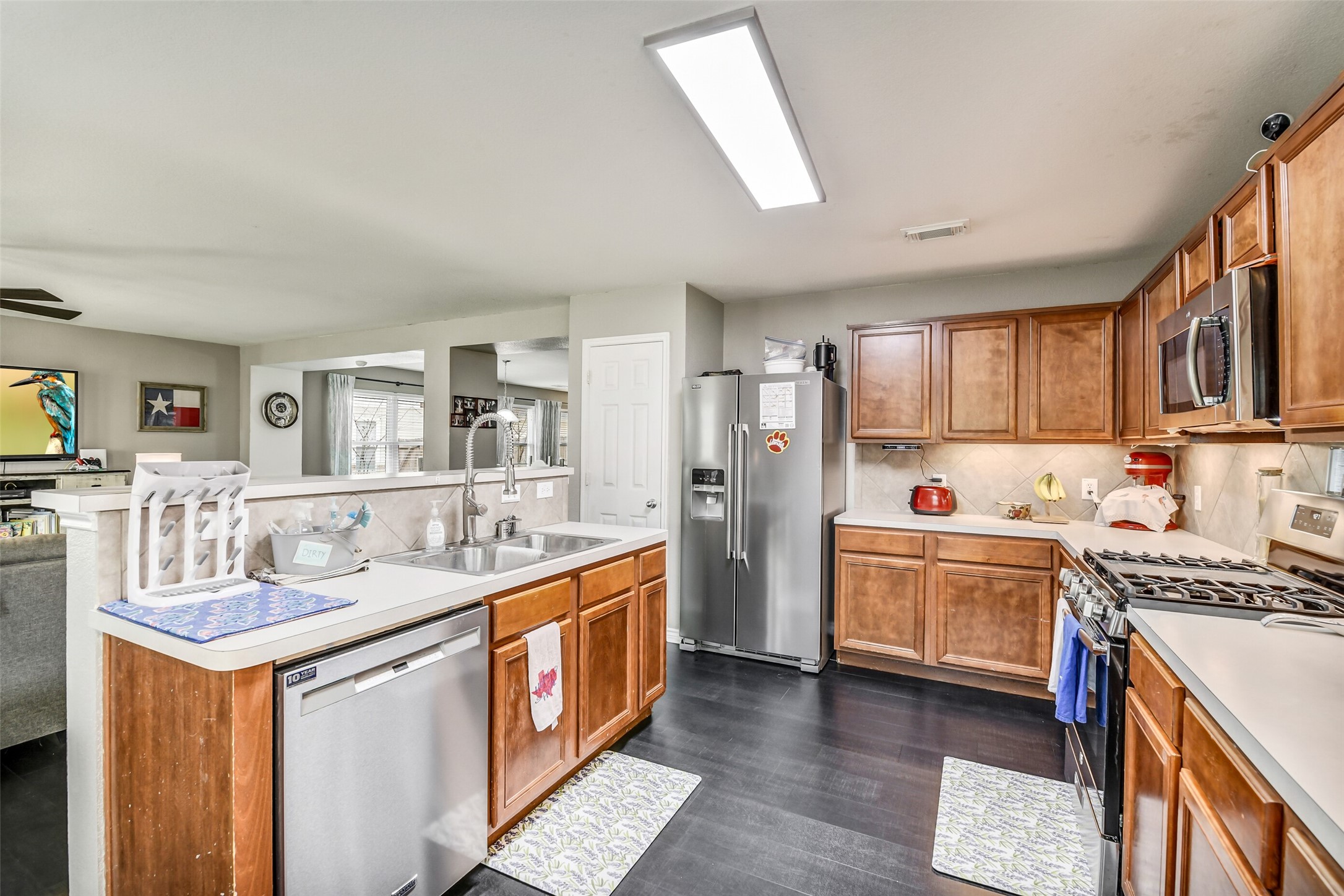 6407 Misty Brook Bend Court Spring, TX 77379 - Photo 8 of 15 a kitchen with stainless steel appliances granite countertop a sink stove and refrigerator
