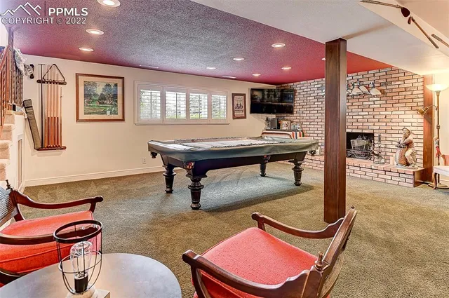 a room with furniture pool table and windows