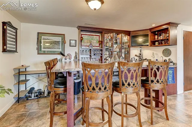 a view of a dining room with furniture and chandelier