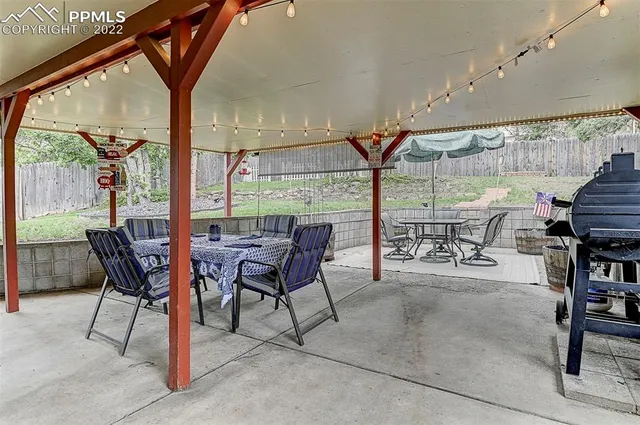 a dining room with furniture and a floor to ceiling window