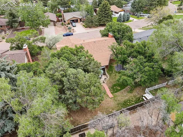 an aerial view of a house with a yard and lake view