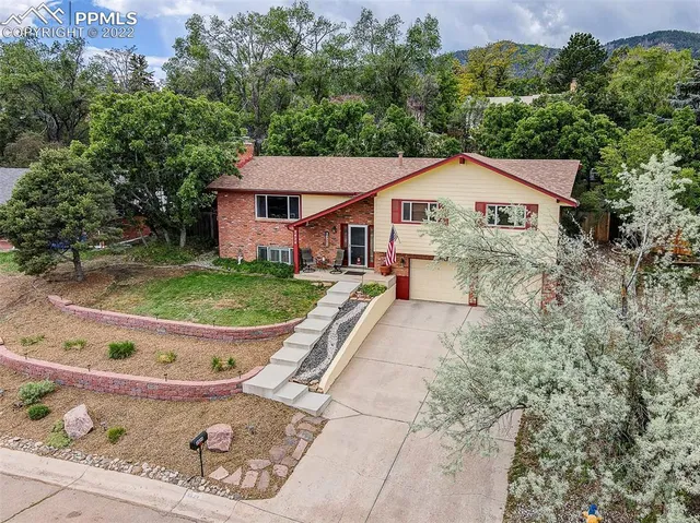 a view of a house with a yard potted plants