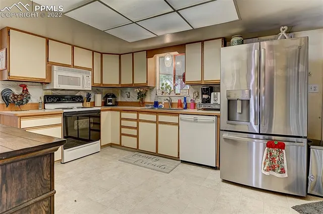 a kitchen with a white cabinets and white appliances