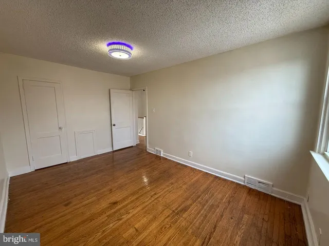 a view of an empty room and wooden floor