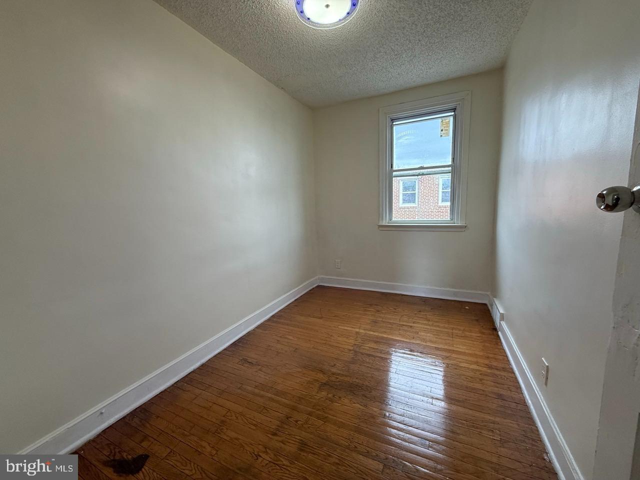 1243 Hellerman Street Philadelphia, PA 19111 - Photo 15 of 20 an empty room with wooden floor and windows