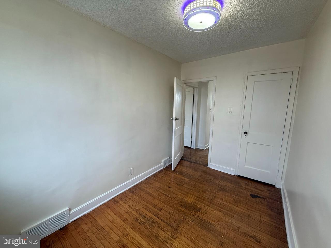 1243 Hellerman Street Philadelphia, PA 19111 - Photo 16 of 20 an empty room with wooden floor and windows