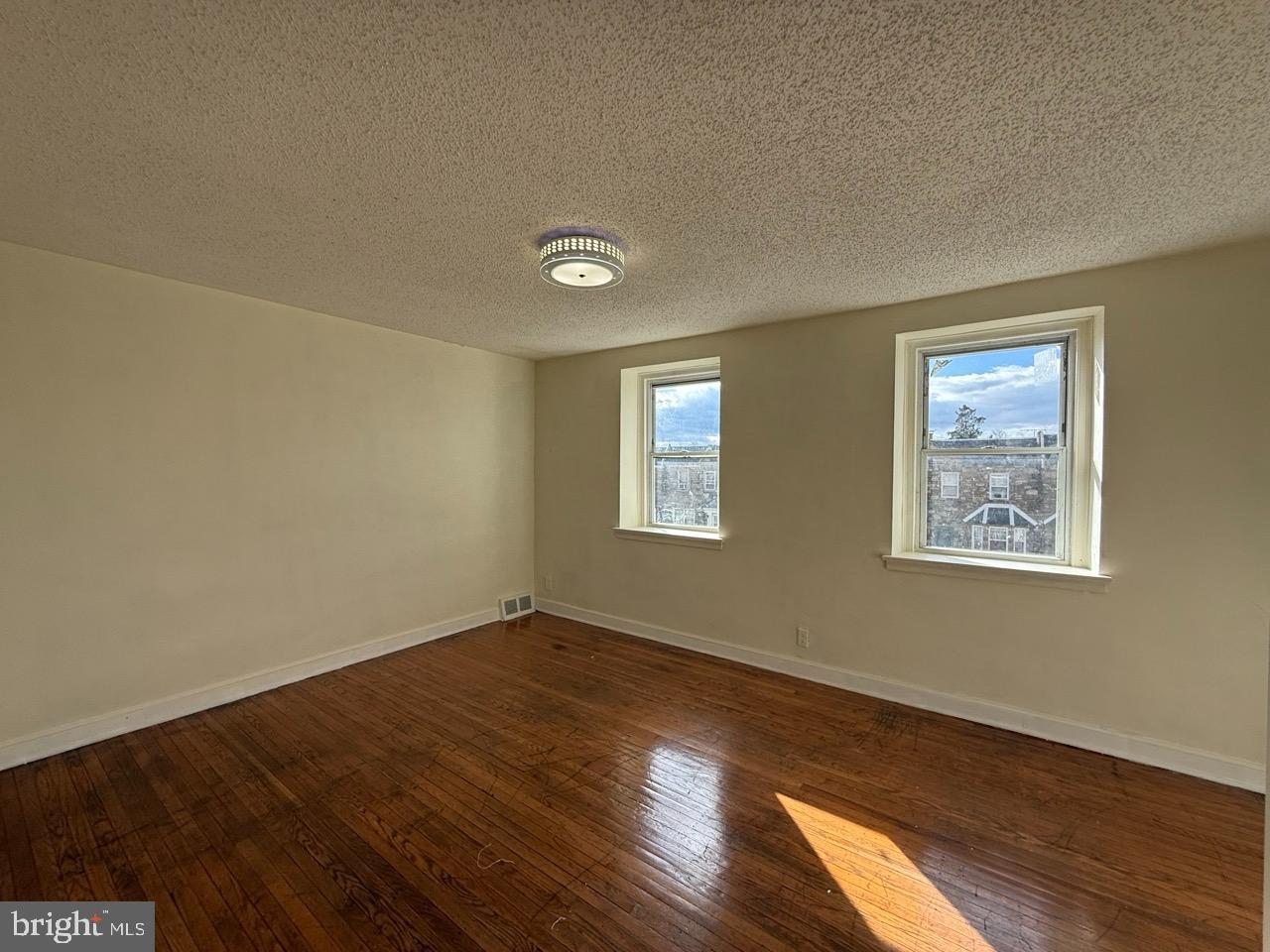 1243 Hellerman Street Philadelphia, PA 19111 - Photo 9 of 20 a view of an empty room with wooden floor and a window