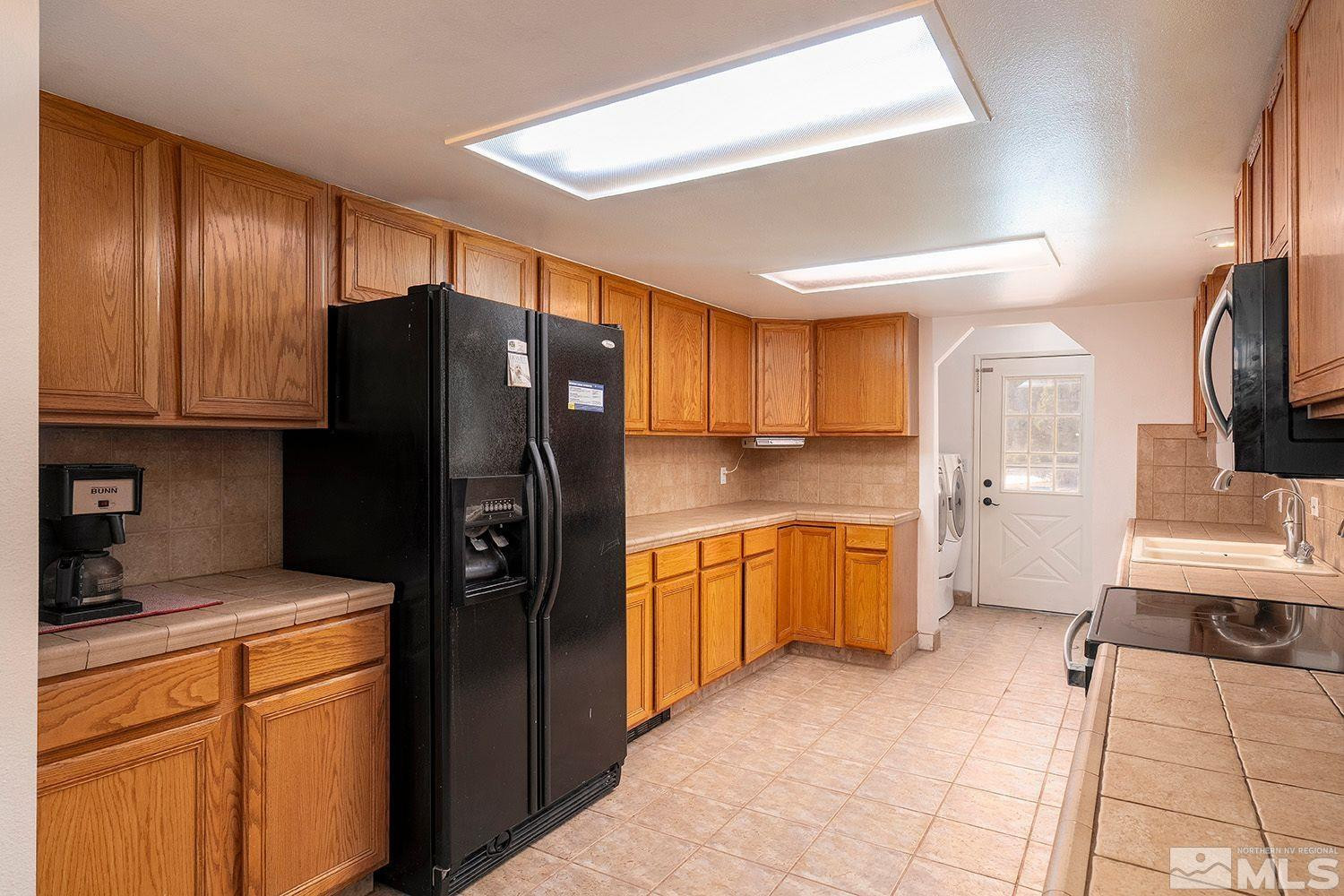 1880 Castle Peak Road Reno, NV 89521 - Photo 11 of 27 a kitchen with stainless steel appliances granite countertop a refrigerator and a stove top oven