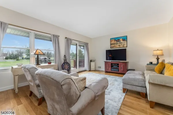 a living room with fireplace furniture and a flat screen tv