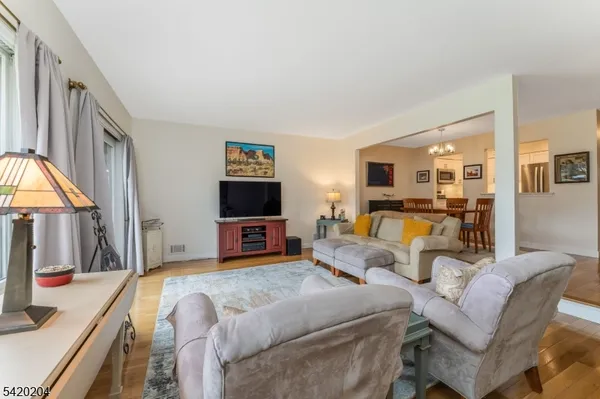 a bedroom with a bed a couch and a flat tv screen next to a window